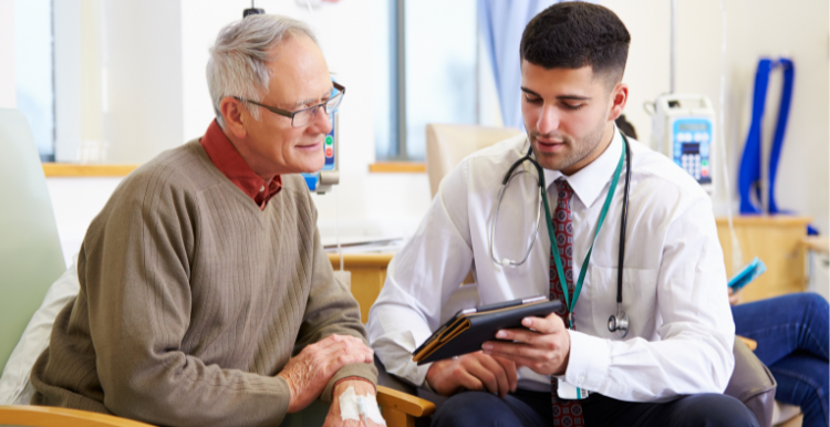 old_man_listening_to_young_male_doctor