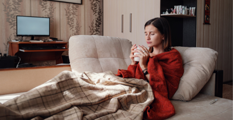 woman_wrapped_in_blankets_drinking_a_hot_drink