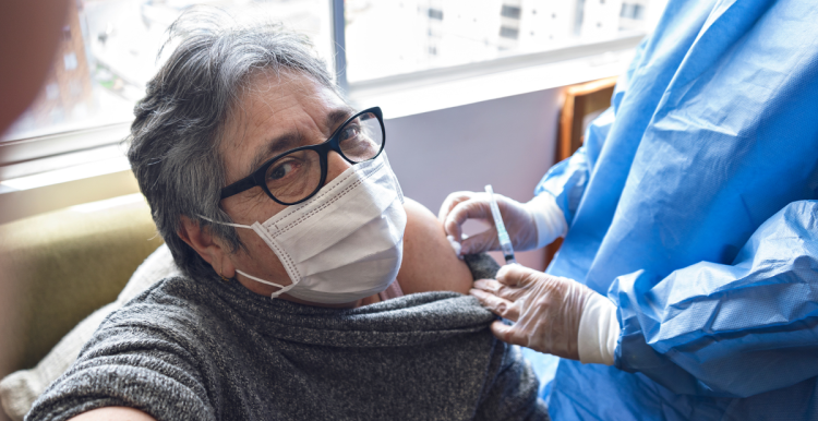 woman_wearing_a_face_mask_being_given_a_covid_vacination