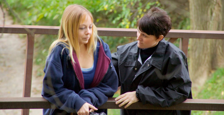 a_young_adult_talking_with_her_carer_while_out_on_a_walk