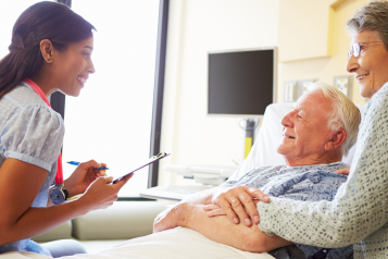 Man_and_woman_talking_to_a_doctor_in_hospital