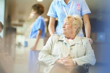 woman_being_pushed_in_a_wheechair_by_a_nurse