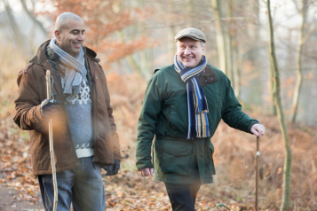 two_men_wrapped_up_warm_going_for_a_winter_walk_in_the_woods