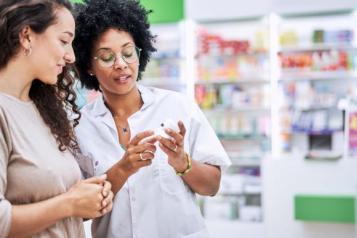 two_women_are_talking_to_each_other_in_a_pharmacy_about_medication