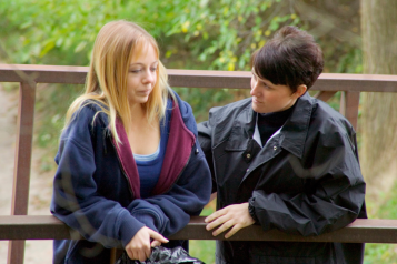 a_young_adult_talking_with_her_carer_while_out_on_a_walk